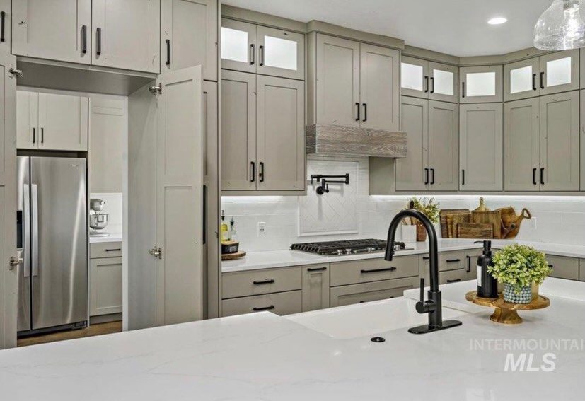 Greige kitchen with window over sink by Porter's Custom Cabinets